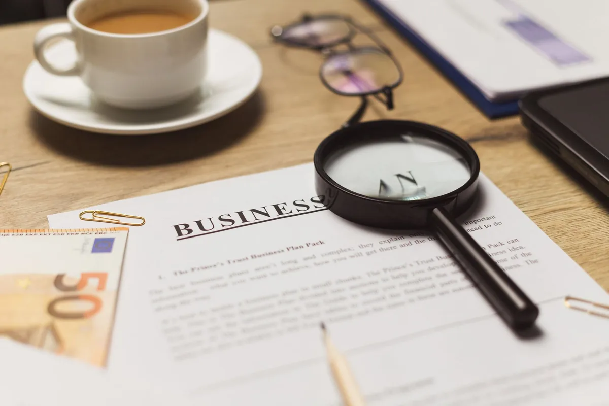 A one-page business plan on a desk being written
